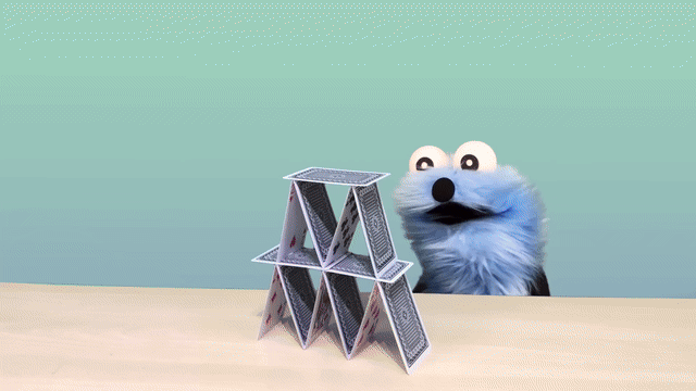Gif of puppet sunsun unable to finish a house of cards dus to being interrupted by dancing