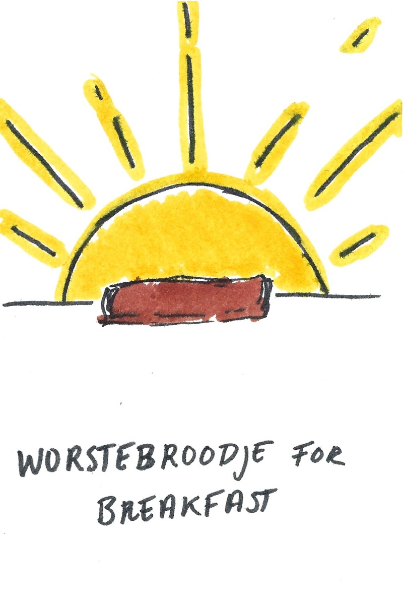 Worstebroodje for breakfast -  A worstebroodje in front of a bright rising sun